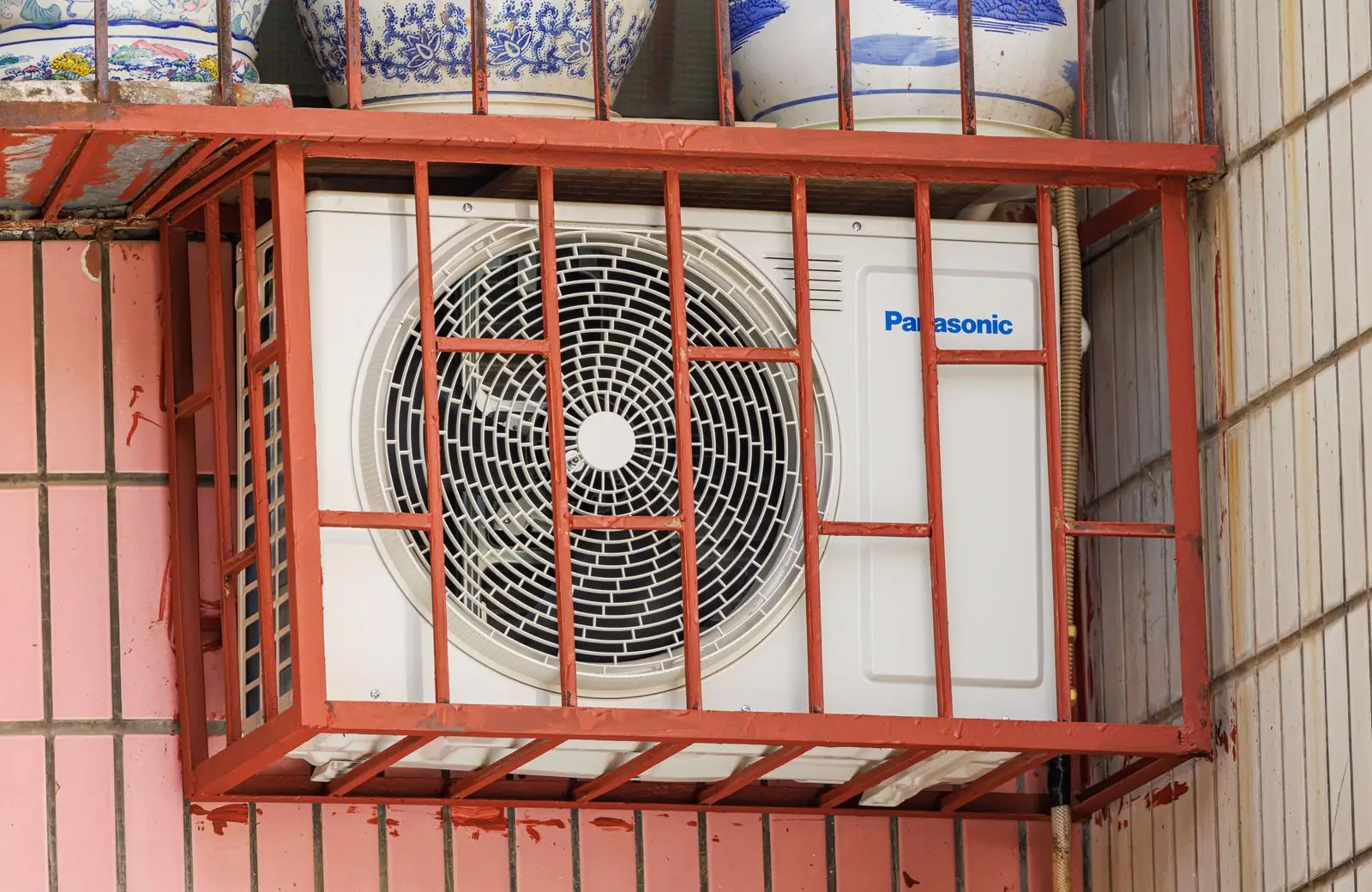 Outdoor condenser unit in a protective cage
